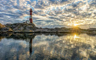 Lighthouse rocky shore sunset clouds 4 - a rocky shore free wallpaper