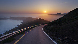 Sunset hill road water matte - a sunset in the background and a body of water free wallpaper
