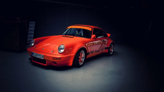 Red sports car dark garage - a dark garage free wallpaper