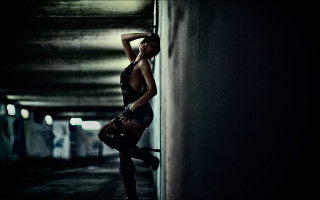Woman black top boots leaning - against a wall free wallpaper