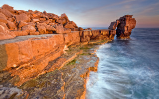 Rocky cliff water rock formation - rich moody colour free wallpaper