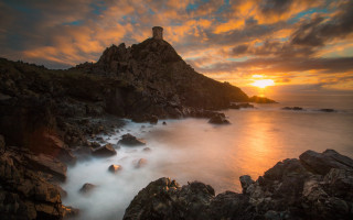 Lighthouse rocky cliff sunset ocean 2 - a rocky cliff free wallpaper