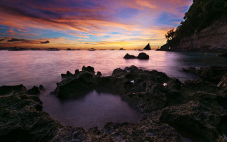 Sunset rocky beach cityscape mountains - a sunset over a rocky beach free wallpaper