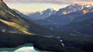 Mountain lake snowcapped clouds beach - a mountain range in the background free wallpaper