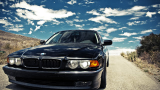Black car dirt road blue - a black car free wallpaper