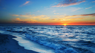Sunset ocean waves boat sky - a sunset over the ocean free wallpaper