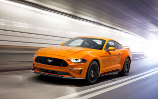 Bright orange mustang driving blurry - f 8 aperture free wallpaper