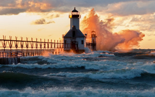 Lighthouse waves ocean sunset cloudy - a lighthouse free wallpaper
