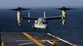 Large airplane flying over ship - over a ship in the ocean free wallpaper