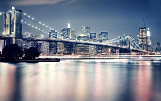 City skyline bridge river night 104 - the water and a boat in the foreground free wallpaper