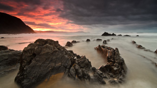 Rocky beach sunset clouds mountain - rich moody colour free wallpaper