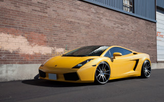 Yellow sports car brick wall 2 - a yellow sports car free wallpaper