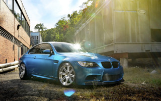 Blue car brick building sun - anamorphic free wallpaper