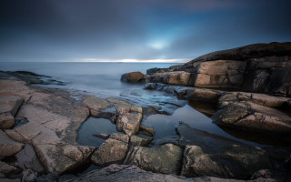Rocky shore sunburst ocean mountains - a rocky shore free wallpaper