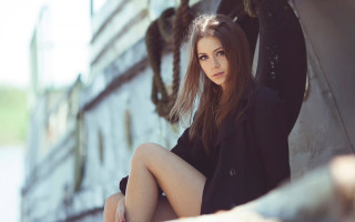 Woman sitting outdoors winter bokeh - the side of a building free wallpaper