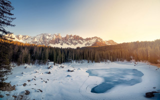 Snowy mountain lake forest sunset 4 - the foreground and a mountain range in the background free wallpaper