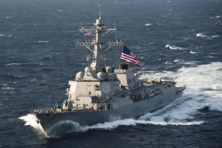 Military ship ocean american flag - a smaller boat in the background free wallpaper
