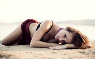 Beach bikini woman laying sand - free bikini wallpaper