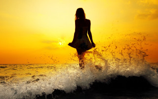 Woman sunset ocean silhouette autumn - the sun setting behind her free wallpaper