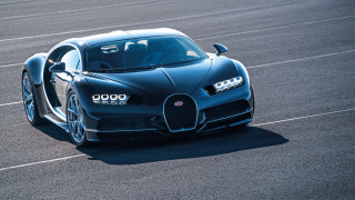 Bugatti racecar hooddown lights on - a race track free wallpaper