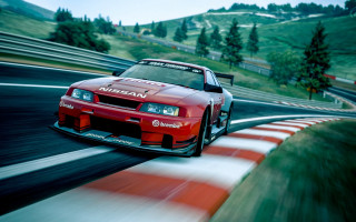 Red car racing green hill - a race track free wallpaper for desktop