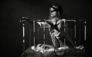 Woman sitting bed cage black - deep shadow free wallpaper