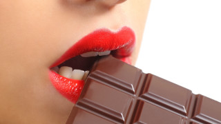 Woman eating chocolate decadent aesthetic - her mouth open free wallpaper