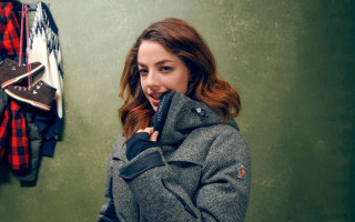 Woman talking cellphone coat wall - caro niederer free wallpaper