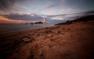 Lighthouse beach cloudy sunset horizon - dave allsop free wallpaper