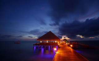 Pier lit hut night boat - rich moody colour free wallpaper