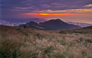 Grassy field mountain sunset city - murata range free wallpaper