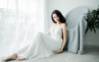 Woman white dress chair window - a white curtain behind her free wallpaper