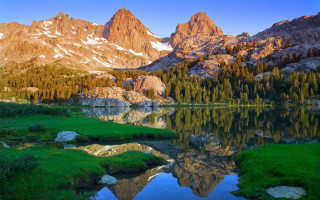 Mountain range lake forest grass - the foreground and a mountain range in the background free wallpaper