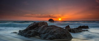 Sunset ocean rocks wave shore - a sunset over the ocean free wallpaper