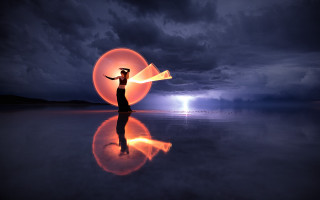 Woman orange object beach night - a lightning free wallpaper