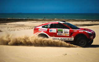 Red car driving sandy ocean - sandy free wallpaper