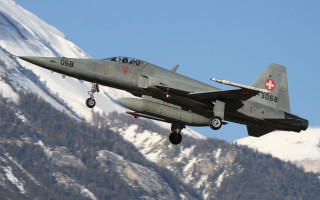 Military jet mountain cross plane - over a mountain range free wallpaper