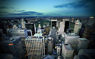 Cityscape tall buildings river nighttime - tall building and a river in the background free wallpaper