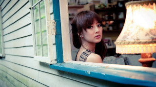Woman window lamp building portrait - promotional image free wallpaper