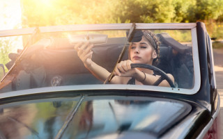Woman driving steering wheel man - her hand and a man holding free wallpaper