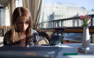 Woman sitting table wine phone - a glass of wine in front free wallpaper