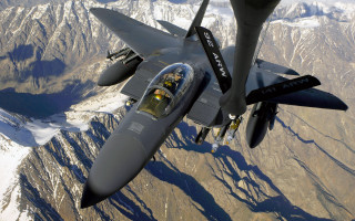 Fighter jet mountain sky pilot - over a mountain range in the sky free wallpaper
