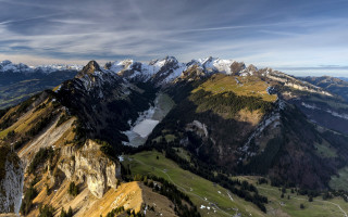 Mountain lake snowcapped cliffs clouds - a view of a mountain range free wallpaper