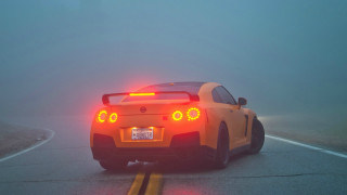 Yellow sports car foggy road - a yellow sports car free wallpaper