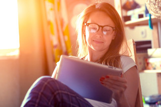 Woman glasses tablet couch window - glass free wallpaper