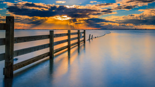 Wooden fence beach cloudy sky - a wooden fence free wallpaper