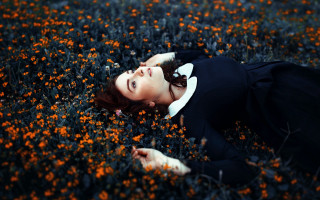 Woman laying flowers eyes closed - evaline ness free wallpaper