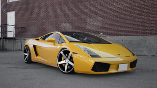 Yellow sports car brick building 2 - a parking meter free wallpaper