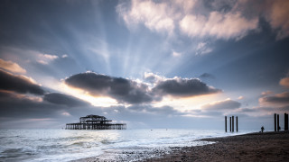 Pier beach cloudy sky water - a body of water below free wallpaper