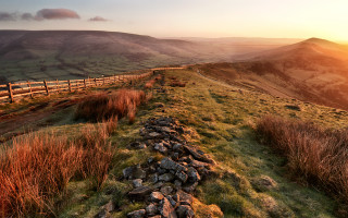 Stone wall grassy hill sunset - a grassy hill free wallpaper